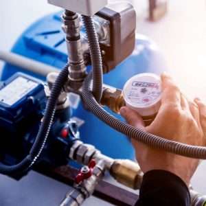 A pump system gauge being checked by a technician.