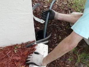 person working on drainage problem in a yard